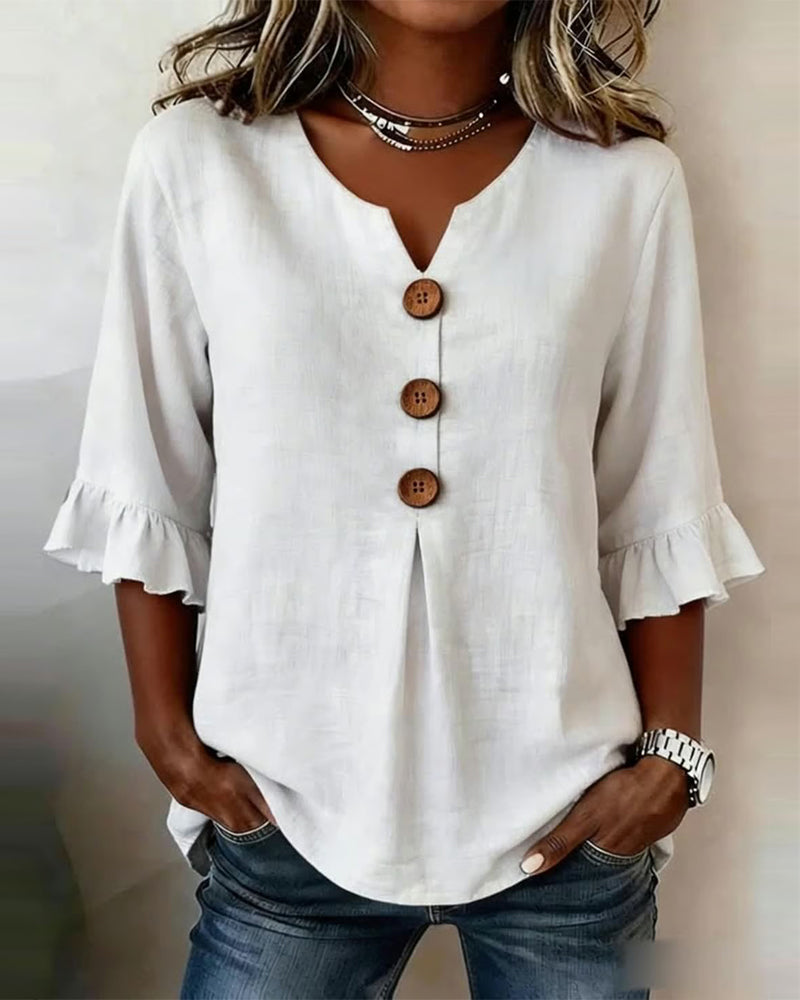 Blusa Inés de algodón-lino lisa con botones de madera y volantes