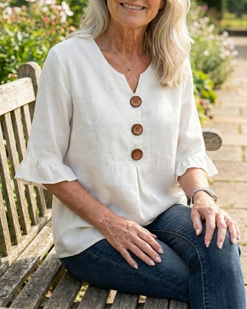 Blusa Inés de algodón-lino lisa con botones de madera y volantes