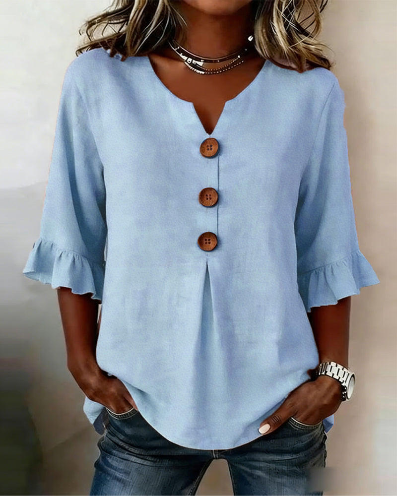 Blusa Inés de algodón-lino lisa con botones de madera y volantes
