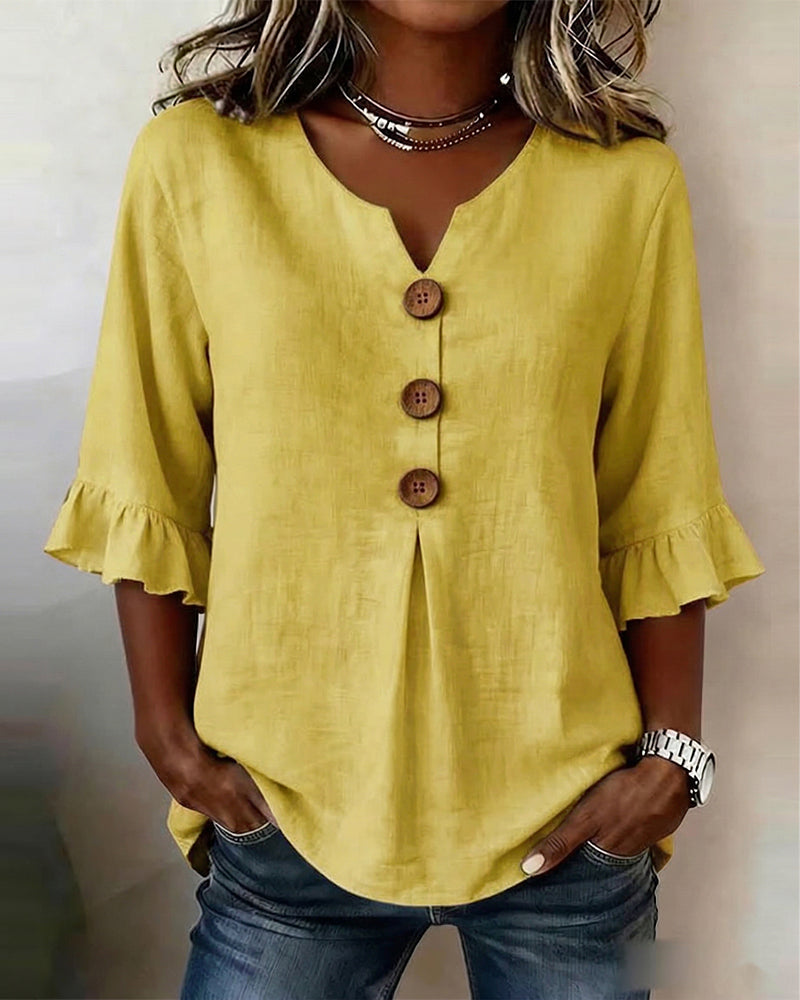 Blusa Inés de algodón-lino lisa con botones de madera y volantes