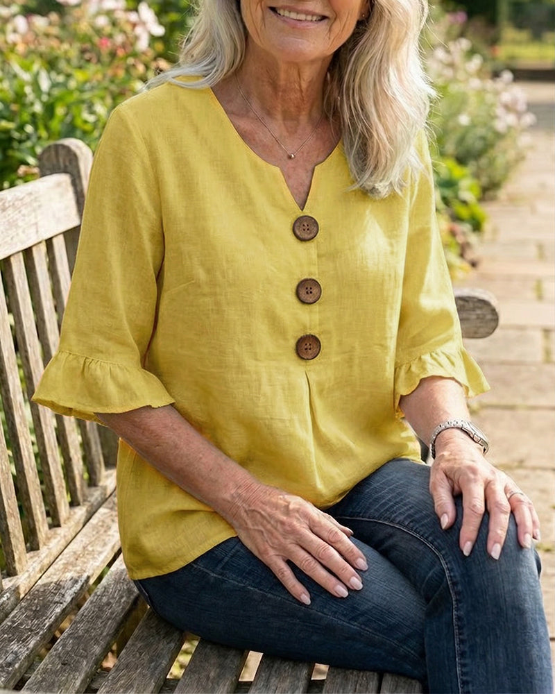 Blusa Inés de algodón-lino lisa con botones de madera y volantes
